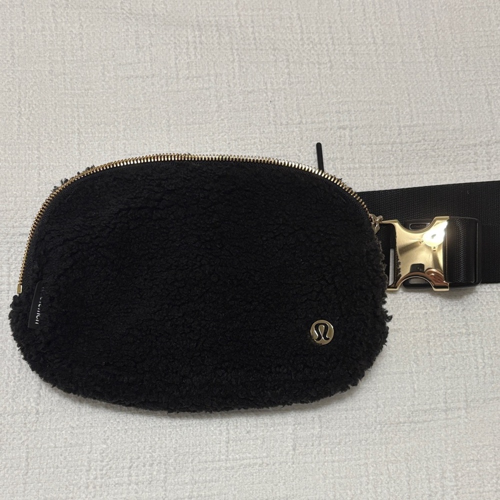 Authentic Lululemon black fleece belt bag with gold hardware